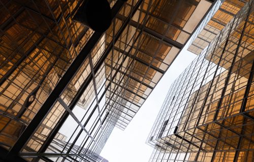 Golden building. Windows glass of modern office skyscrapers in technology and business concept. Facade design. Construction structure of architecture exterior for urban cityscape background. Golden building. Windows glass of modern office skyscrapers in technology and business concept. Facade design. Construction structure of architecture exterior for urban cityscape background.